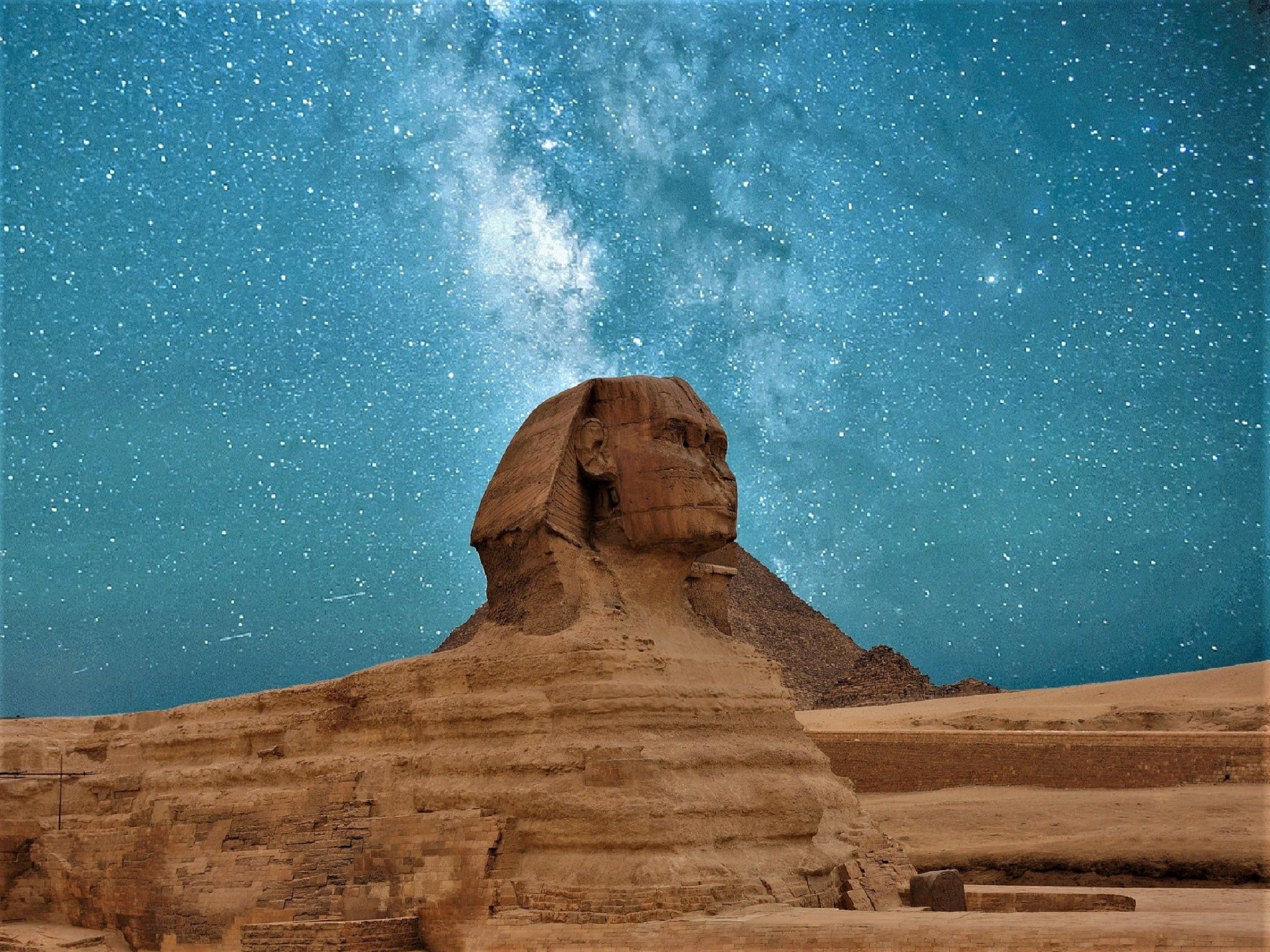 Egyptian sphinx gazing into a starry night sky.