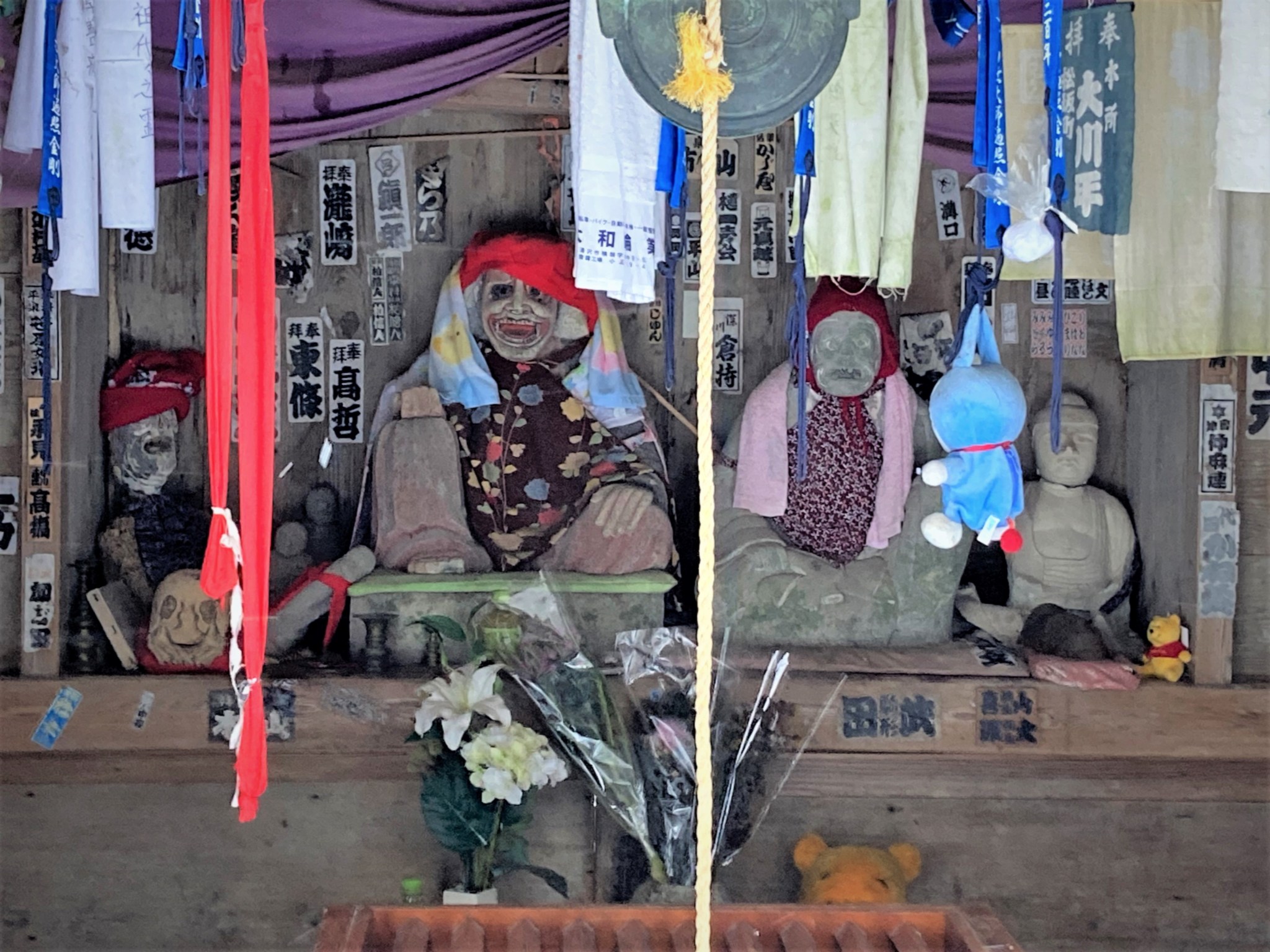 A collection of grotesque stone statues and other curios at a shrine at the Japanese temple complex of Risshaku-ji.