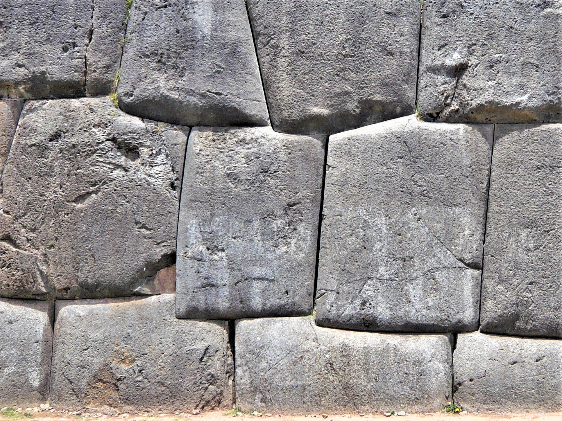 An ancient and forbidding monumental stone wall with irregular shaped blocks.